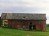 Another early stage picture of a barn roof being refinished by Miller Roofing LLC